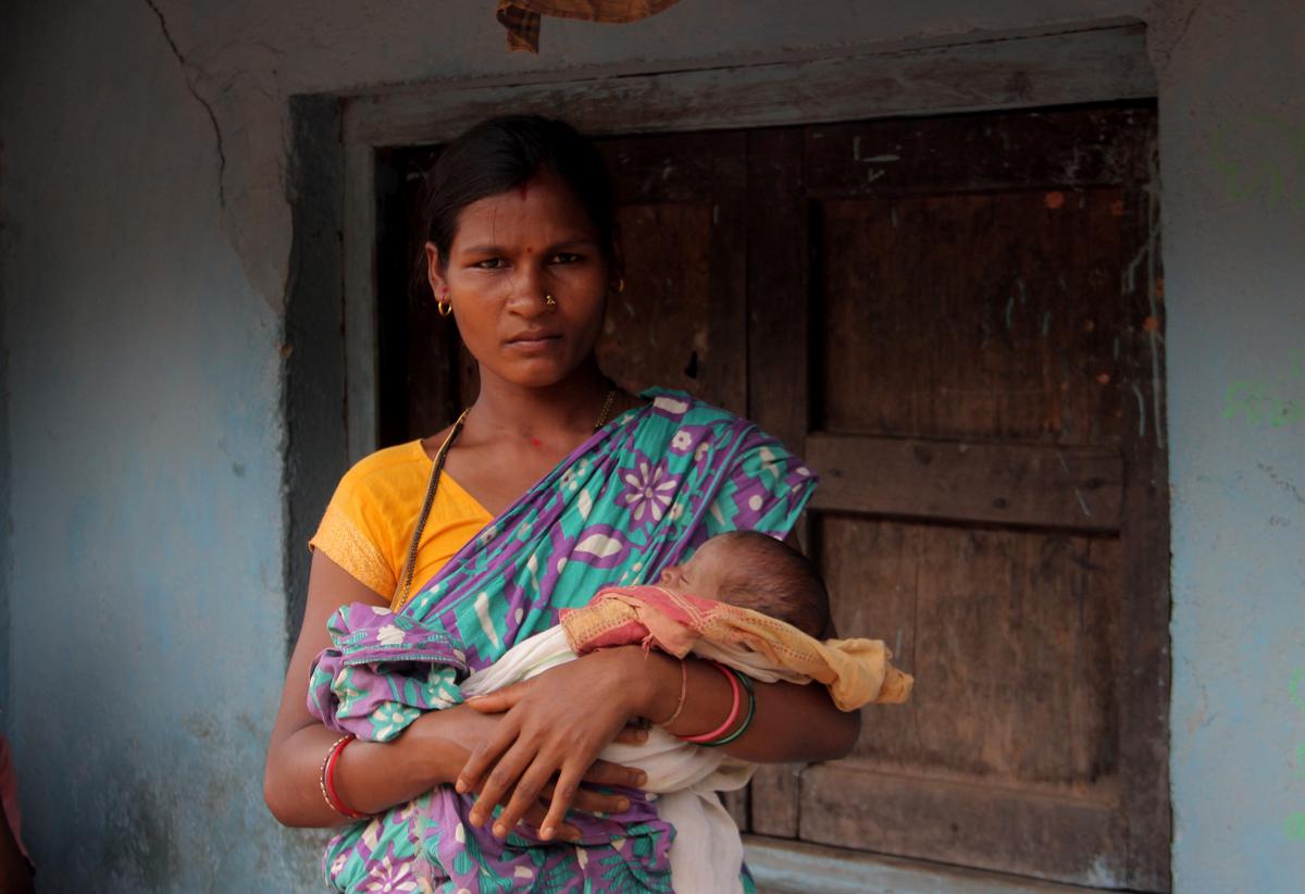 Dibai Majhi, from the Kondh tribe, cradles her newborn in Aliguna village, on the foothills of the Sijimali, a proposed bauxite mining area.